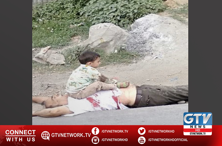 Image of Kashmiri child sitting on the body of grandfather shakes humanity